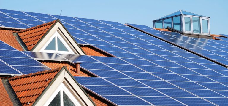 Dach mit Gauben und Photovoltaikmodulen drauf.